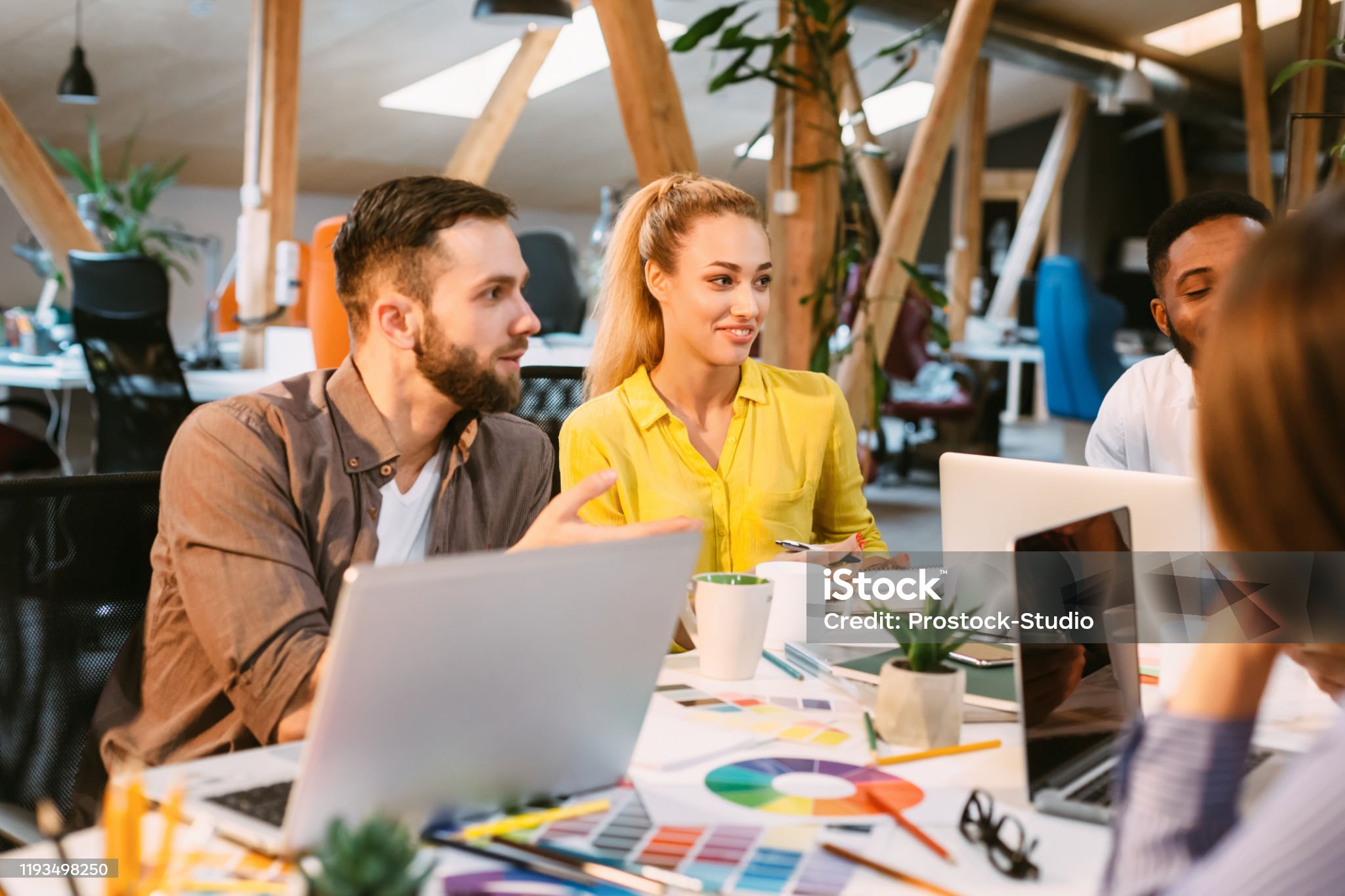 Brainstorming concept. Designers discussing new ideas at meeting in modern office